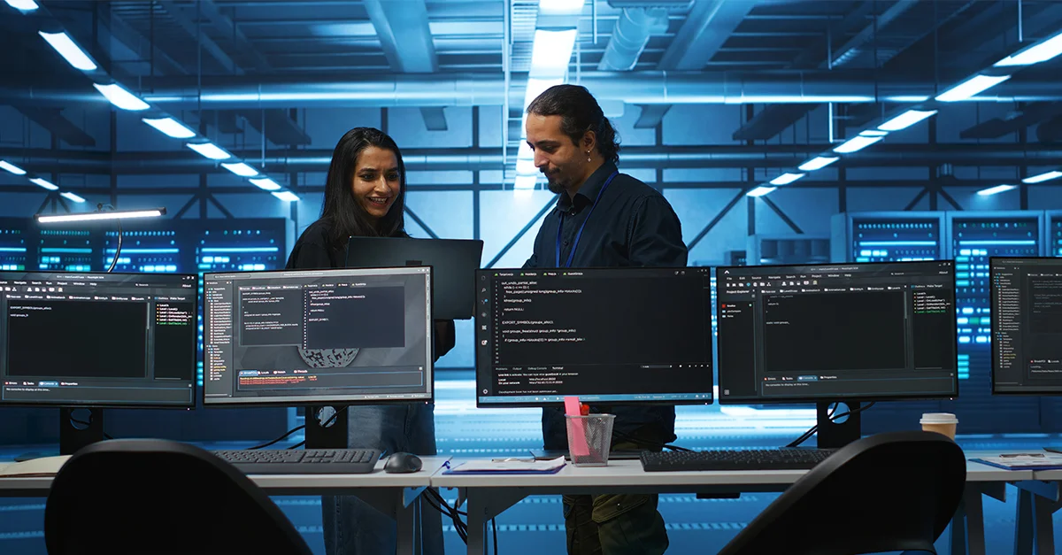 cyber security team discussing behind computers